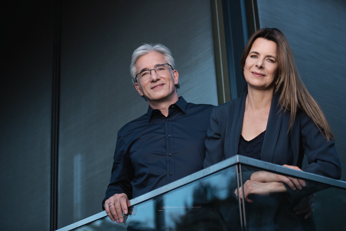Mann und Frau am Geländer in blauer Lichtstimmung